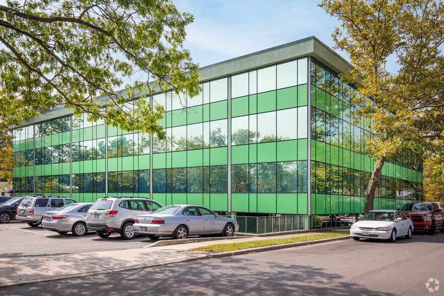 734 Walt Whitman Rd — green glass office building exterior